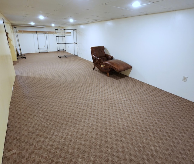 unfurnished room featuring a paneled ceiling and carpet flooring