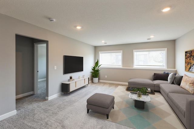 living room with light carpet and a textured ceiling