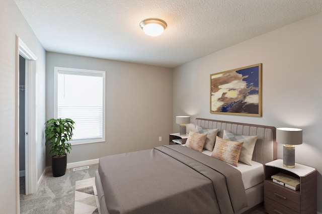 carpeted bedroom featuring a textured ceiling