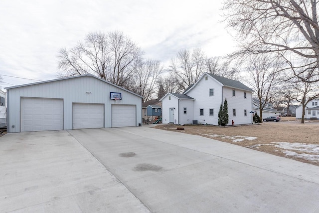 view of side of property with a garage and an outbuilding