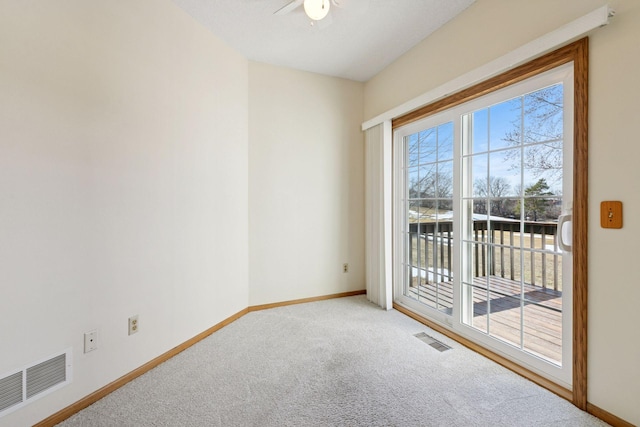 unfurnished room with carpet flooring, plenty of natural light, and visible vents