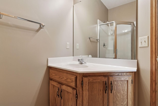 full bath with a shower stall and vanity