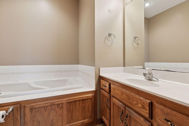 full bath featuring vanity and a bath