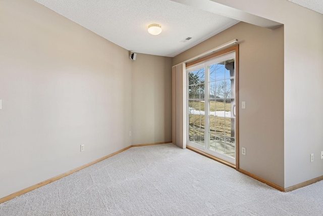 empty room featuring baseboards, carpet floors, and a textured ceiling