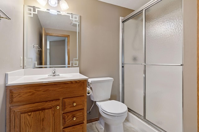 full bathroom featuring tile patterned floors, vanity, toilet, and a shower stall