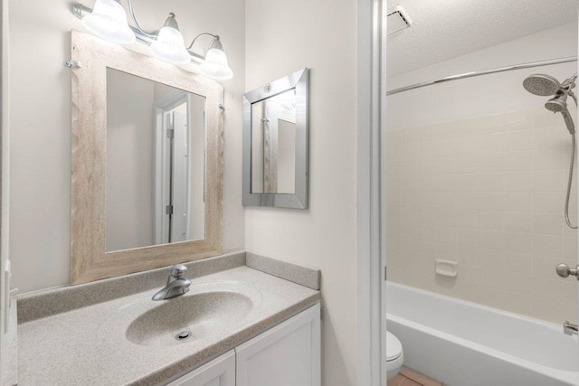 full bath featuring shower / bathtub combination, a textured ceiling, vanity, and toilet