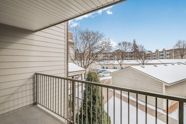 view of snow covered back of property