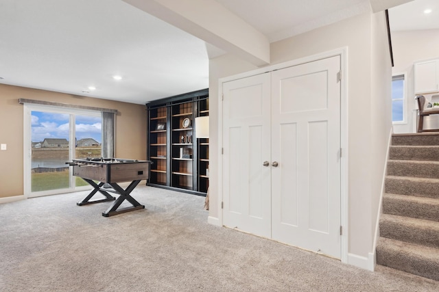 misc room with beamed ceiling and carpet