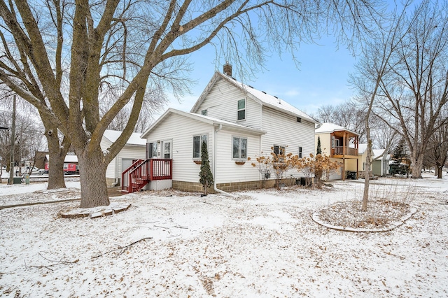 view of snow covered rear of property