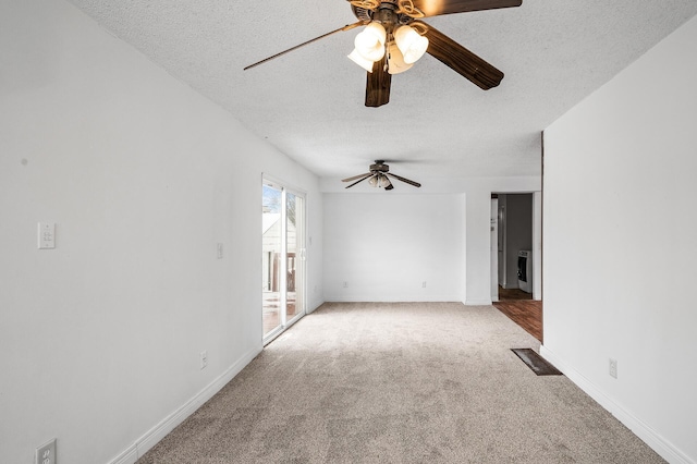 unfurnished living room with light carpet, ceiling fan, and a textured ceiling