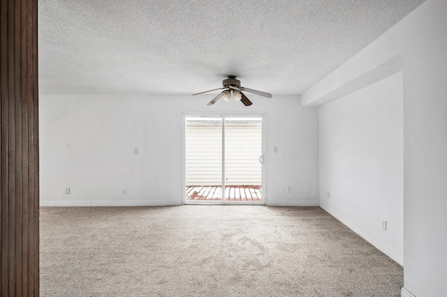 empty room with light carpet, a textured ceiling, and ceiling fan