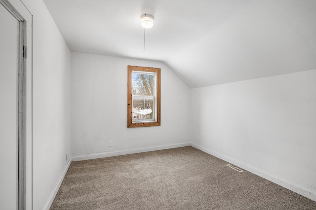 bonus room featuring vaulted ceiling and carpet floors