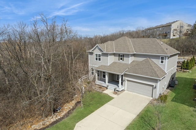 5270 Jewel Ln N, Plymouth, MN 55446 - traditional-style home with a porch, a front yard, a garage, roof with shingles, and concrete driveway