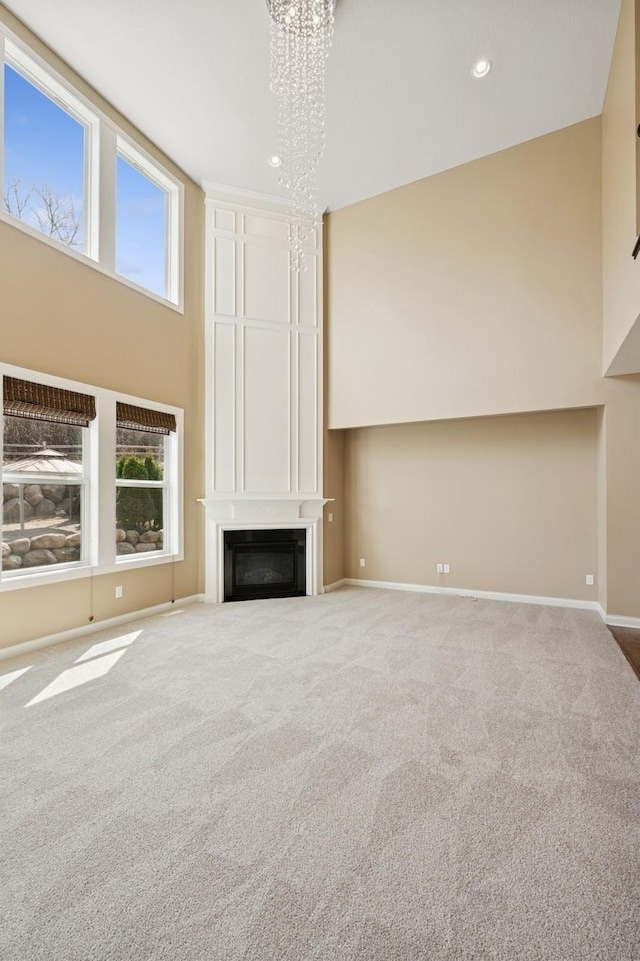 5270 Jewel Ln N, Plymouth, MN 55446 - unfurnished living room featuring a chandelier, a large fireplace, carpet, baseboards, and recessed lighting