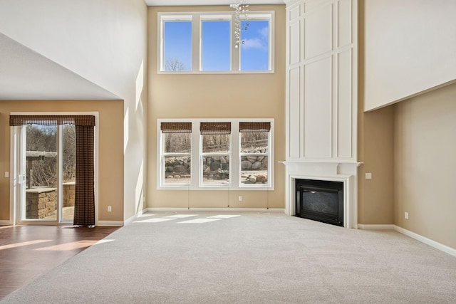 5270 Jewel Ln N, Plymouth, MN 55446 - unfurnished living room with carpet flooring, a fireplace, baseboards, and a high ceiling