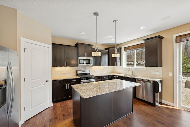 5270 Jewel Ln N, Plymouth, MN 55446 - kitchen with appliances with stainless steel finishes, dark brown cabinets, backsplash, dark wood finished floors, and recessed lighting