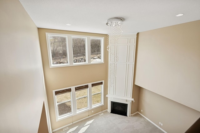 5270 Jewel Ln N, Plymouth, MN 55446 - unfurnished living room featuring carpet flooring, plenty of natural light, baseboards, and a large fireplace
