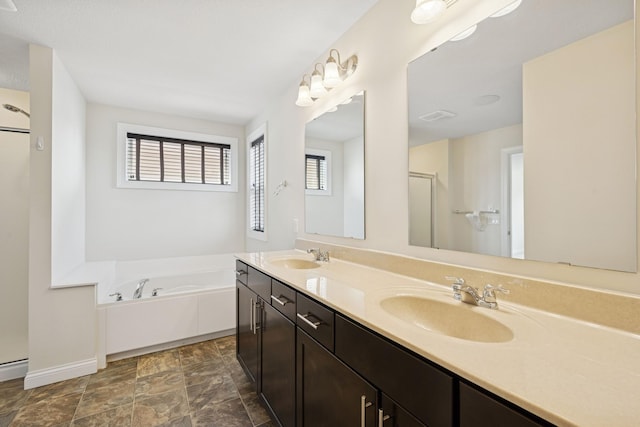 5270 Jewel Ln N, Plymouth, MN 55446 - full bathroom with double vanity, a garden tub, a shower, baseboards, and stone finish floors