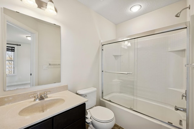 5270 Jewel Ln N, Plymouth, MN 55446 - bathroom with vanity, toilet, combined bath / shower with glass door, and a textured ceiling