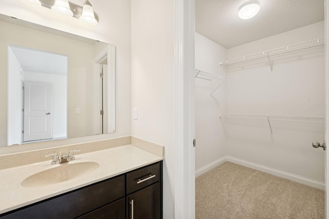 5270 Jewel Ln N, Plymouth, MN 55446 - bathroom featuring vanity, a textured ceiling, and baseboards