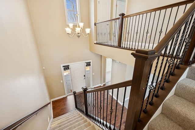 5270 Jewel Ln N, Plymouth, MN 55446 - stairway with a chandelier, a towering ceiling, carpet, and baseboards