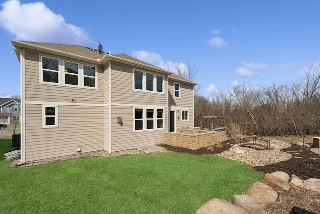 5270 Jewel Ln N, Plymouth, MN 55446 - rear view of house featuring a yard, central air condition unit, and roof with shingles