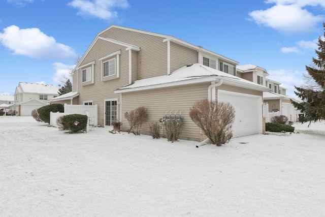 view of snow covered back of property