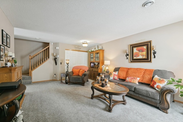 living room with a textured ceiling and carpet