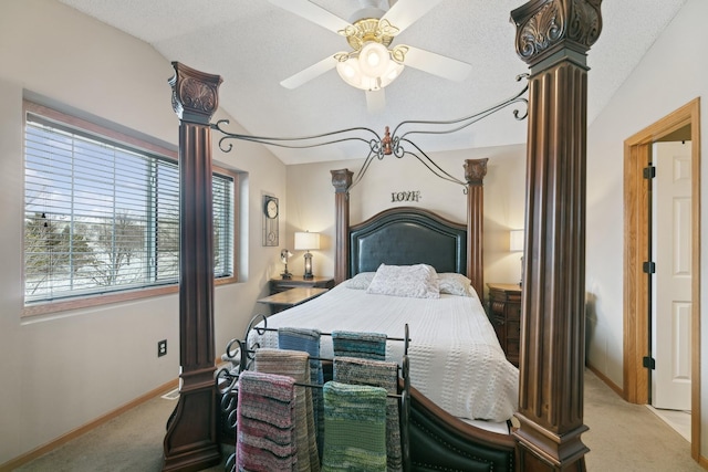 carpeted bedroom with lofted ceiling, a textured ceiling, ceiling fan, and ornate columns