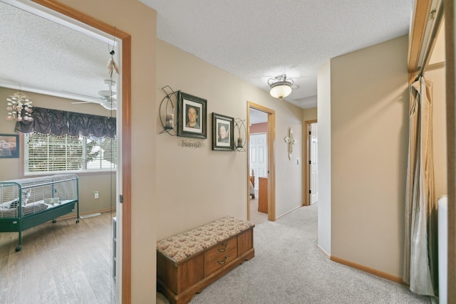 hallway with a textured ceiling