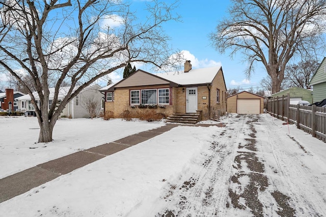 view of front of property with a garage and an outdoor structure