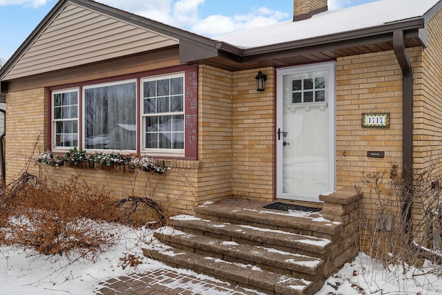 view of snow covered property entrance