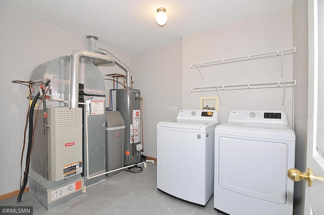 washroom with washer and dryer and gas water heater