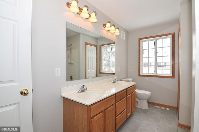 bathroom featuring vanity, tile patterned floors, and toilet