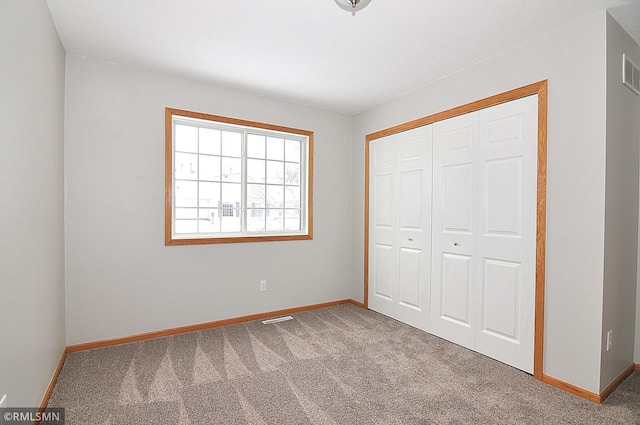 unfurnished bedroom with carpet flooring and a closet