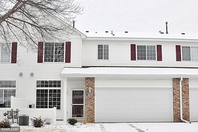 view of front facade featuring a garage and central AC