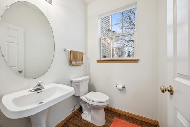 bathroom with sink, hardwood / wood-style floors, and toilet