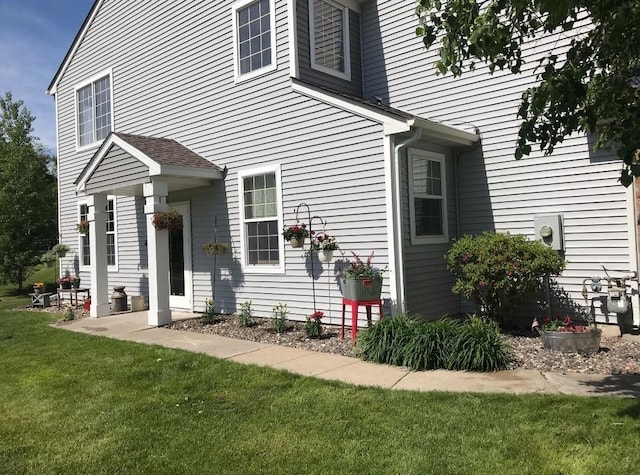 view of side of home featuring a yard