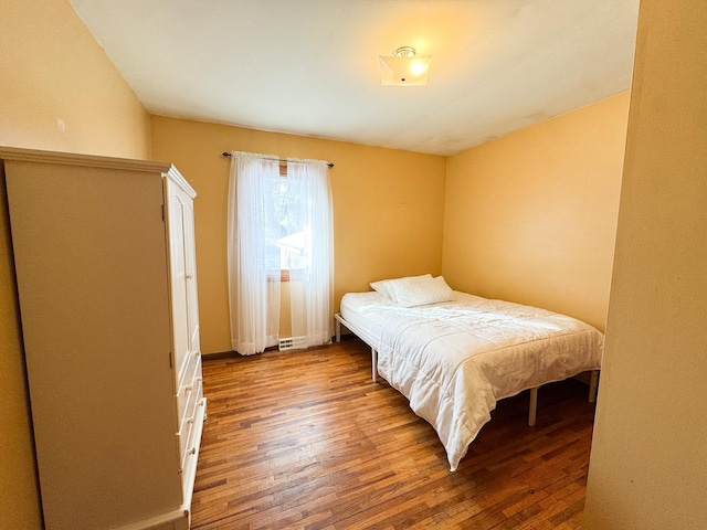 bedroom with wood finished floors