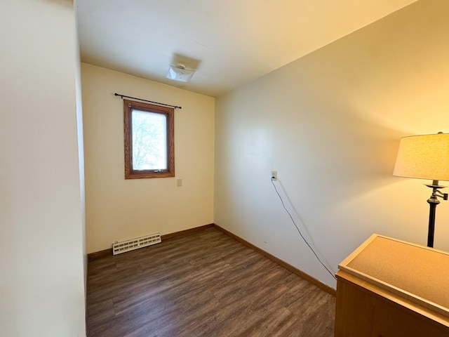 empty room featuring dark wood-type flooring, baseboards, and visible vents