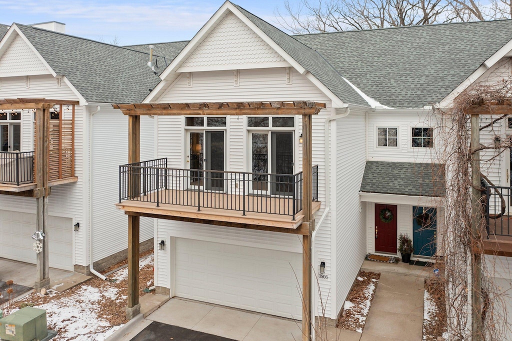 view of front of house featuring a balcony and a garage