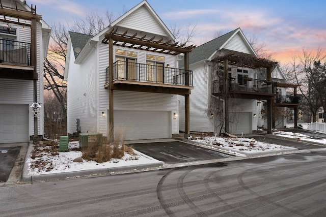 view of front of house with cooling unit, a balcony, and a garage