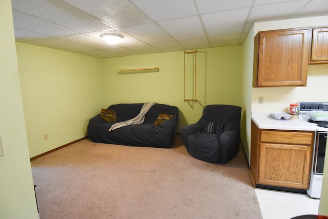 sitting room featuring light carpet and a paneled ceiling