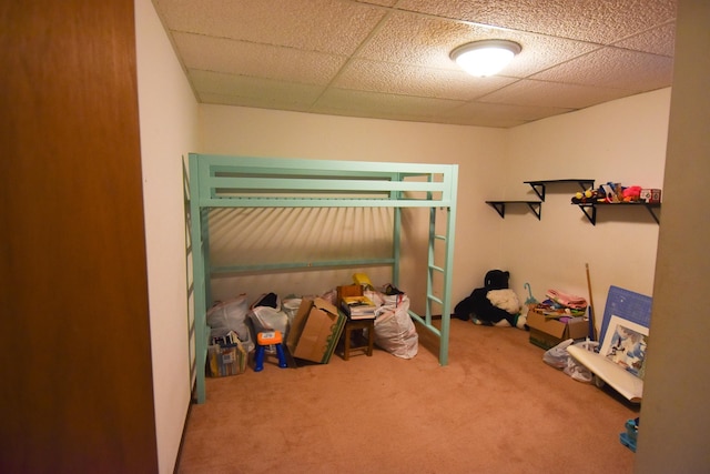 bedroom with a paneled ceiling and carpet flooring