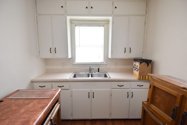 kitchen featuring white cabinetry and sink