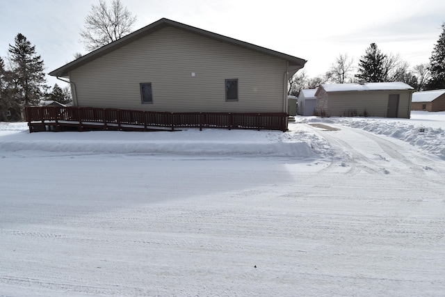 snow covered property with a wooden deck