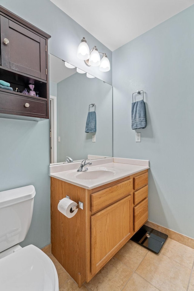 bathroom with vanity, tile patterned flooring, and toilet