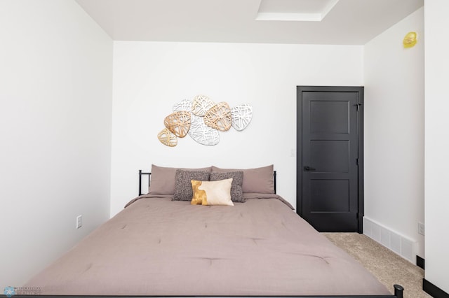 carpeted bedroom featuring visible vents