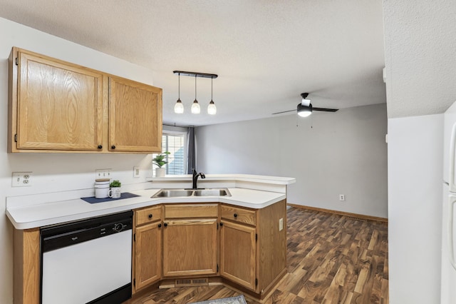 kitchen with a peninsula, a sink, hanging light fixtures, light countertops, and dishwasher