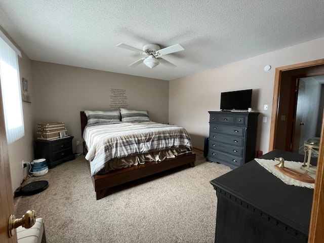 bedroom with light colored carpet, a textured ceiling, and ceiling fan